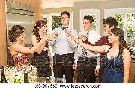 Stock Image - Teens at graduation party. Fotosearch