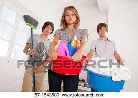 Teens bored with housework View Large Photo Image Stock Image - Teens bored with housework. Fotosearch