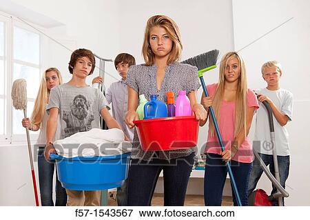 Teens bored with housework View Large Photo Image Stock Photo - Teens bored with housework. Fotosearch