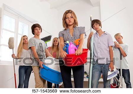 Teens bored with housework View Large Photo Image Stock Photo - Teens bored with housework. Fotosearch