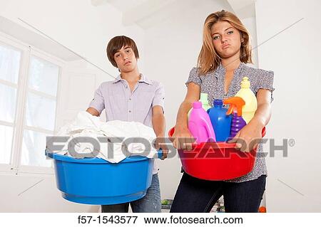 Teens bored with housework View Large Photo Image Stock Photo - Teens bored with housework. Fotosearch