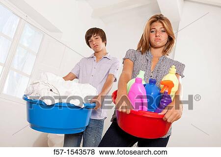 Teens bored with housework View Large Photo Image Stock Photo - Teens bored with housework. Fotosearch