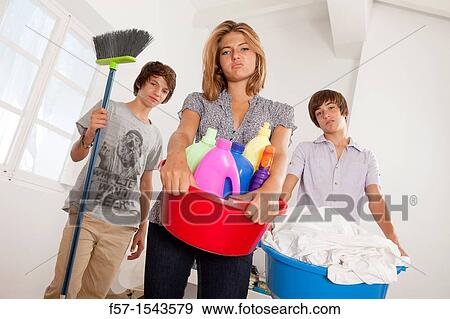 Teens bored with housework View Large Photo Image Stock Photo - Teens bored with housework. Fotosearch