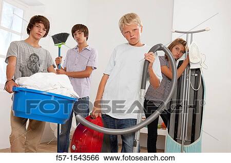 Teens bored with housework View Large Photo Image Stock Photograph - Teens bored with housework. Fotosearch