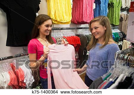 Teens deciding on purchase View Large Photo Image Picture - Teens deciding on purchase. Fotosearch