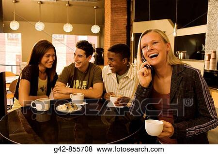 Stock Photo - Teens hanging out in coffee shop.. Fotosearch