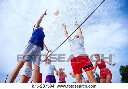 teens playing beach volleyball View Large Photo Image Picture - teens playing beach volleyball. Fotosearch