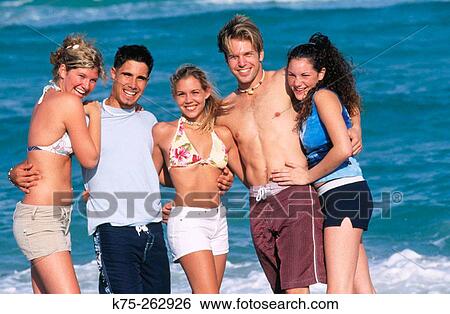 Teens pose for photo at the beach View Large Photo Image Stock Photograph - Teens pose for photo at the beach. Fotosearch