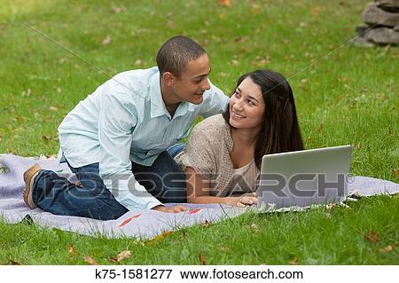 Teens studying together with laptop View Large Photo Image Stock Photo - Teens studying together with laptop. Fotosearch