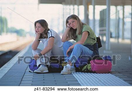 Teens waiting at train station View Large Photo Image Picture - Teens waiting at train station. Fotosearch