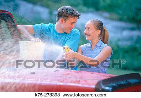 Stock Photo - teens washing jeep. Fotosearch