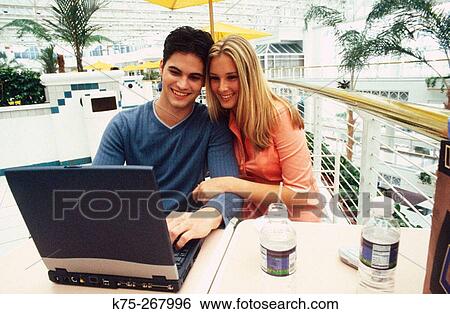 Teens with laptop at cafe View Large Photo Image Stock Photograph - Teens with laptop at cafe. Fotosearch