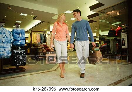 Stock Photography - Teens with their purchases at mall. Fotosearch
