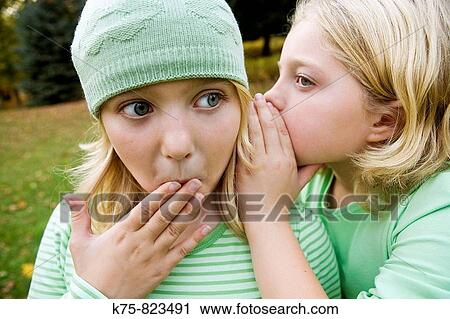 telling a secret View Large Photo Image Stock Image - telling a secret. Fotosearch