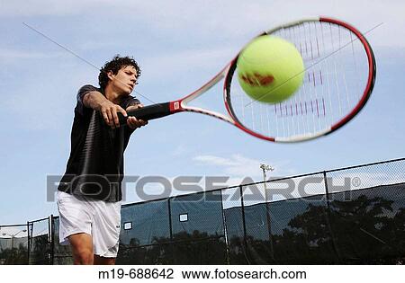 Tennis player hitting with a giant-sized racket View Large Photo Image Stock Image - Tennis player hitting with a giant-sized racket. Fotosearch
