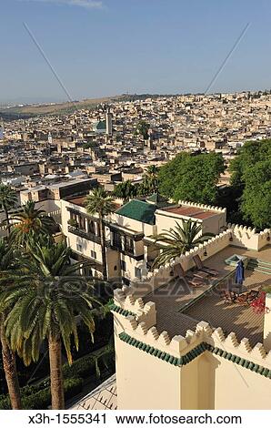 Stock Image - terraces and garden of the luxury Palais Jamai hotel with the Medina background Fes, Morocco, North Africa. Fotosearch