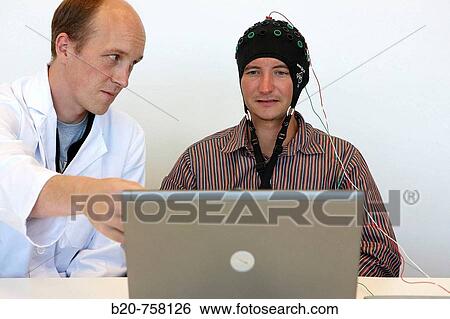 Stock Photograph - Testing a BCI (Brain-Computer Interface) developed by Health and Quality of life Unit researchers, FIK technology research program for aged and disabled people. Fatronik-Tecnalia, Research and Technology Center, Donostia, Basque Country, Spain. Fotosearch