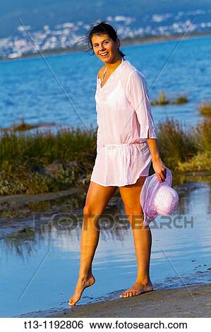 Testing cold sea young woman View Large Photo Image Stock Photograph - Testing cold sea young woman. Fotosearch