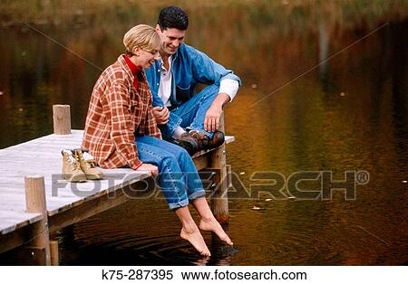 Stock Photography - testing the water from the dock. Fotosearch