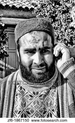 Testour in Tunisia Africa portrait of Muslim man in native dress with modern cell phone View Large Photo Image Stock Image - Testour in Tunisia Africa portrait of Muslim man in native dress with modern cell phone. Fotosearch