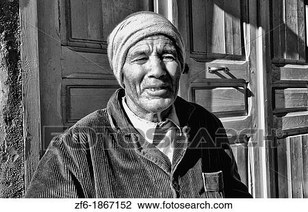 Stock Image - Testour in Tunisia Africa portrait of old Muslim man in native dress and red hat. Fotosearch