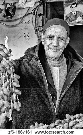Testour in Tunisia Africa portrait of old Muslim man selling date in native dress View Large Photo Image Stock Image - Testour in Tunisia Africa portrait of old Muslim man selling date in native dress. Fotosearch