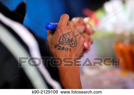 Thai man having a tatoo on his hand that says "Love", Mae Hong Son, Thailand, Southeast Asia. View Large Photo Image Stock Photo - Thai man having a tatoo on his hand that says "Love", Mae Hong Son, Thailand, Southeast Asia.. Fotosearch