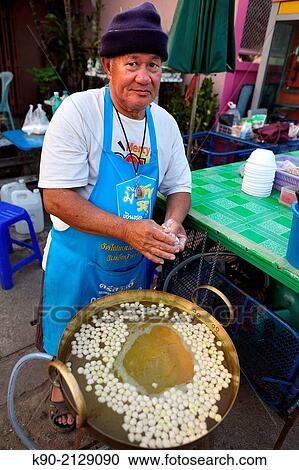 Thai man preparing rice flour balls with sweetened cocont milk and young coconut juice, Mae Hong Son, Thailand, Southeast Asia. View Large Photo Image Stock Image - Thai man preparing rice flour balls with sweetened cocont milk and young coconut juice, Mae Hong Son, Thailand, Southeast Asia.. Fotosearch