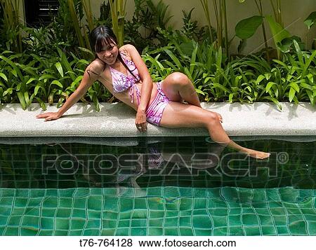 Thai model relaxing by the swimming pool on Koh Samui Island in Thailand View Large Photo Image Stock Photo - Thai model relaxing by the swimming pool on Koh Samui Island in Thailand. Fotosearch