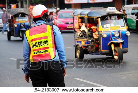 Thai police officer in the traffic chaos of Bangkok View Large Photo Image Stock Photo - Thai police officer in the traffic chaos of Bangkok. Fotosearch