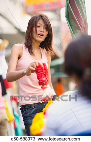 Thai woman (age 24) shopping in street market, Bangkok, Thailand View Large Photo Image Stock Image - Thai woman (age 24) shopping in street market, Bangkok, Thailand. Fotosearch