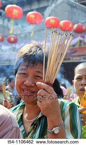 Thai Woman with Incence Sticks in a Temple View Large Photo Image Stock Image - Thai Woman with Incence Sticks in a Temple. Fotosearch