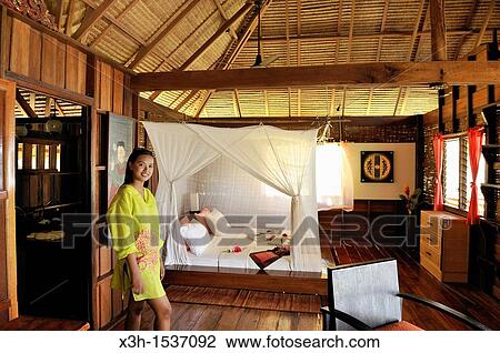 Thai young woman, cottage's bedroom, Koh Jum Lodge, Koh Jum Island, Krabi, Thailand, Asia View Large Photo Image Stock Image - Thai young woman, cottage's bedroom, Koh Jum Lodge, Koh Jum Island, Krabi, Thailand, Asia. Fotosearch