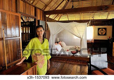 Stock Image - Thai young woman, cottage's bedroom, Koh Jum Lodge, Koh Jum Island, Krabi, Thailand, Asia. Fotosearch