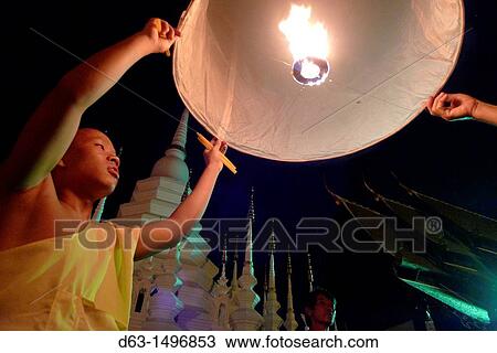 THAILAND Chiang Mai Loi Krathong lantern Festival Buddhist monks and tourists lighting and launching lanterns which float in the sky View Large Photo Image Stock Image - THAILAND Chiang Mai Loi Krathong lantern Festival Buddhist monks and tourists lighting and launching lanterns which float in the sky. Fotosearch