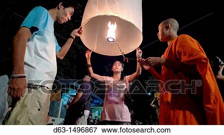 THAILAND Chiang Mai Loi Krathong lantern Festival Buddhist monks and tourists lighting and launching lanterns which float in the sky View Large Photo Image Stock Photo - THAILAND Chiang Mai Loi Krathong lantern Festival Buddhist monks and tourists lighting and launching lanterns which float in the sky. Fotosearch