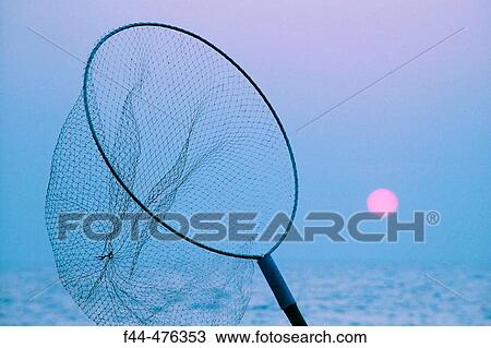 Stock Image - Thailand, Pattaya, Jomtien Beach, Fisher net against sunset [blue]. Fotosearch