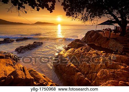 Stock Photo - Thailand - Phuket Island, Patong Beach, sunset time scenery. Fotosearch