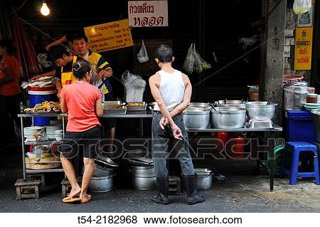 Thais wait for the food at a food stall in Bangkok View Large Photo Image Stock Photo - Thais wait for the food at a food stall in Bangkok. Fotosearch
