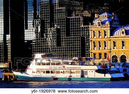 Thames Cruiser passing City of London buildings on the north bank of the River Thames on a sunny day in England View Large Photo Image Stock Photo - Thames Cruiser passing City of London buildings on the north bank of the River Thames on a sunny day in England. Fotosearch