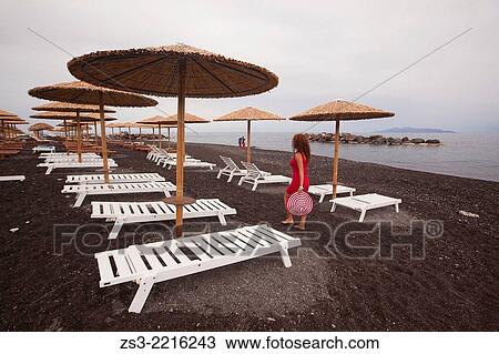 Thatched parasols and tourists in Kamari beach, Santorini, Cyclades Islands, Greek Islands, Greece, Europe. View Large Photo Image Stock Image - Thatched parasols and tourists in Kamari beach, Santorini, Cyclades Islands, Greek Islands, Greece, Europe.. Fotosearch