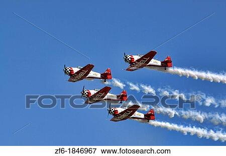 The Aeroshell demonstration team soars overhead in the blue skies of the Dayton Airshow View Large Photo Image Stock Photo - The Aeroshell demonstration team soars overhead in the blue skies of the Dayton Airshow. Fotosearch