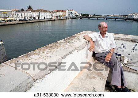 Stock Image - The ancient roman bridge. Historic city of Tavira, probably the nicest in Algarve, has 37 churches. Portugal. Fotosearch