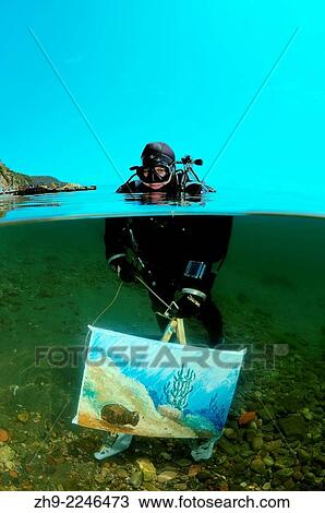 The assistant shows a picture of the artist written by under water artist Yuriy Alexeev (Yuri Alekseev). Lake Baikal, Listvyanka, Irkutsky District, Irkutsk Oblast, Siberia, Russia, Eurasia. View Large Photo Image Stock Image - The assistant shows a picture of the artist written by under water artist Yuriy Alexeev (Yuri Alekseev). Lake Baikal, Listvyanka, Irkutsky District, Irkutsk Oblast, Siberia, Russia, Eurasia.. Fotosearch