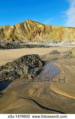 The beach and cliffs at Rockham Bay, Mortehoe, Devon, England, United Kingdom View Large Photo Image Stock Image - The beach and cliffs at Rockham Bay, Mortehoe, Devon, England, United Kingdom. Fotosearch