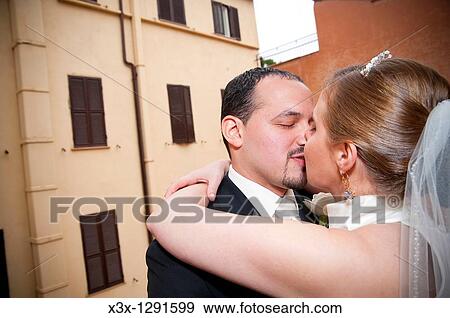 The bride and groom kissing View Large Photo Image Stock Photo - The bride and groom kissing. Fotosearch