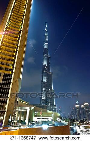 The Burj Al Khalifa tower illuminated at night near the Dubai Mall in Dubai, UAE View Large Photo Image Stock Photo - The Burj Al Khalifa tower illuminated at night near the Dubai Mall in Dubai, UAE. Fotosearch