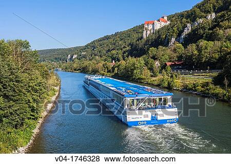Stock Photo - The charming Prunn castle in the Altmuehltal with a cruise ship in the foreground, Bavaria, Germany, Europe. Fotosearch