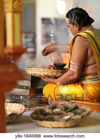 The Chief Priest praying and performing holy rituals inside a Hindu Temple in Malaysia View Large Photo Image Stock Photo - The Chief Priest praying and performing holy rituals inside a Hindu Temple in Malaysia. Fotosearch
