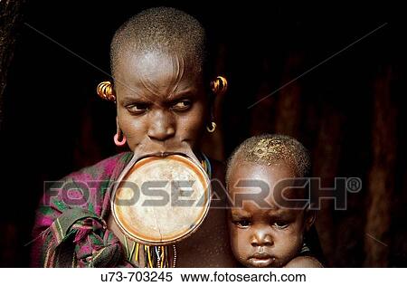 The Colorful Surma tribe live along the Kibish river near the border of Sudan in the lower Omo valley, Ethiopia View Large Photo Image Stock Photography - The Colorful Surma tribe live along the Kibish river near the border of Sudan in the lower Omo valley, Ethiopia. Fotosearch